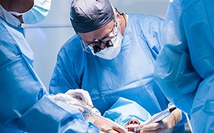 A dentist performing a dental implant surgery